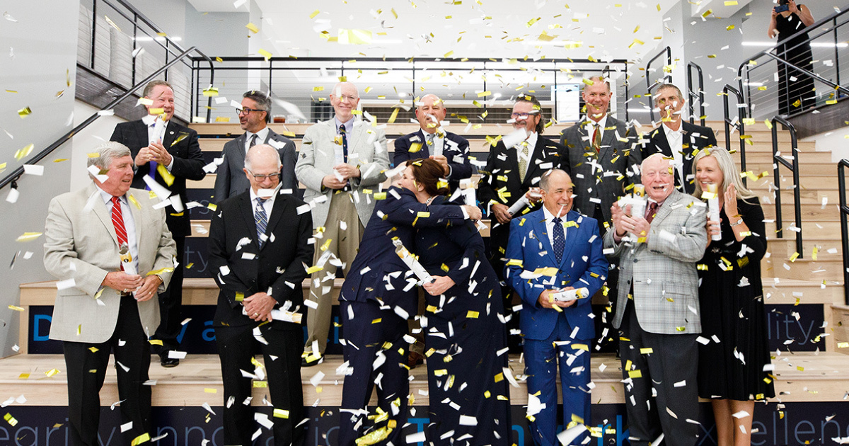 A group of people shot with a confetti cannon.