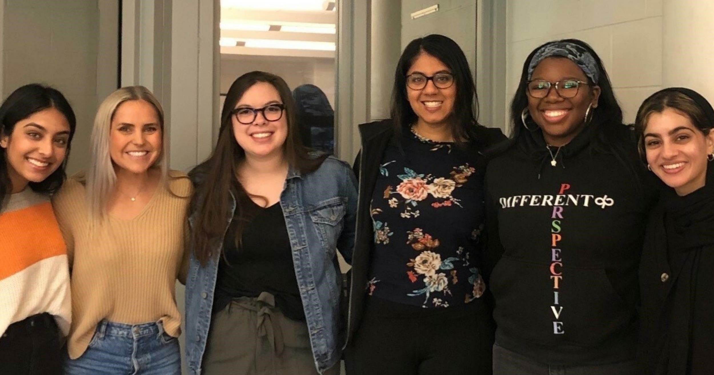 Six female KansasCOM students pose for a photo.