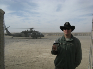 McGill standing in front of a helicopter.