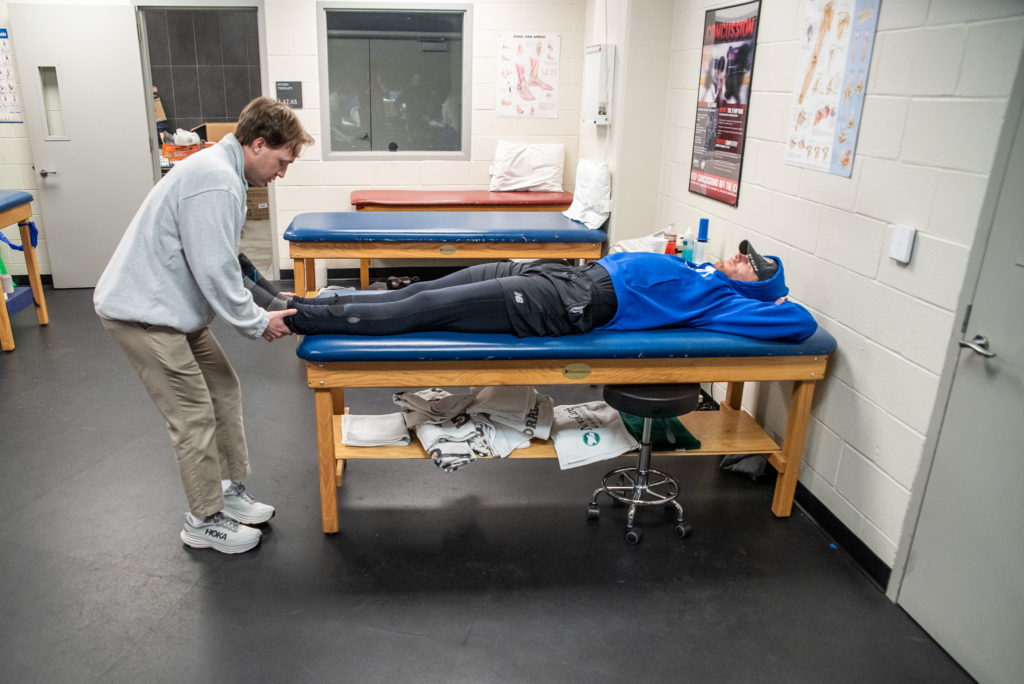 A KHSC - KansasCOM medical student works with a hockey player of the Witchita Thunder.