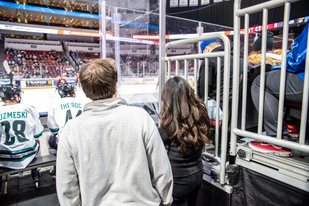 Two KHSC-KansasCOM medical students watch a Witchita Thunder hockey game.