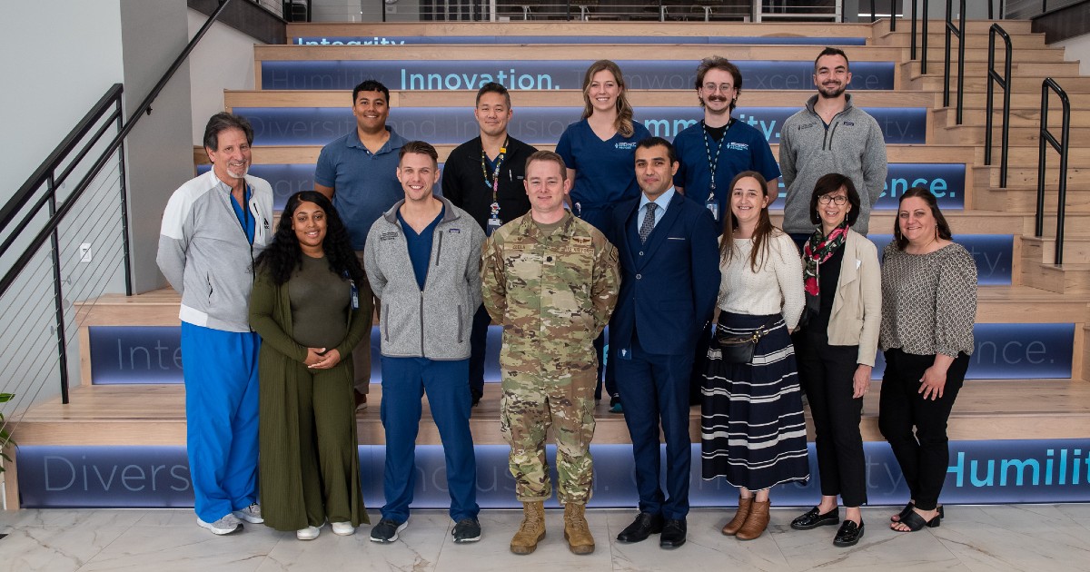 A group of KansasCOM students pose in a group photo with Lt Col Mike Zeola, MD.