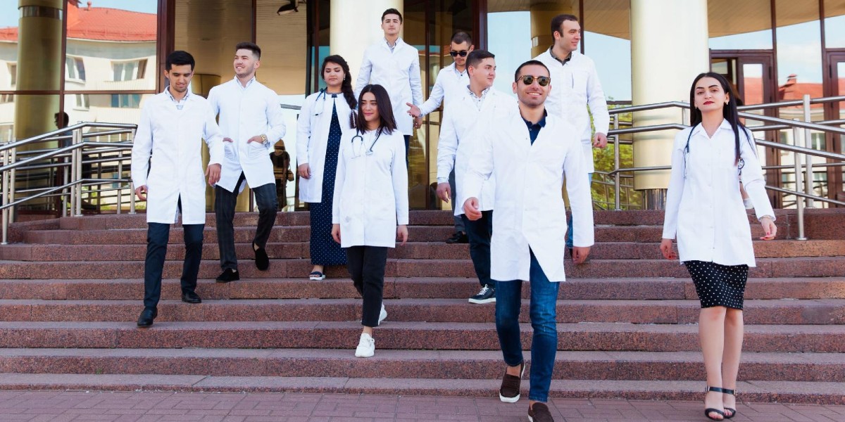 A group of cool young medical students wearing lab coats descend the stairs in front of a building.