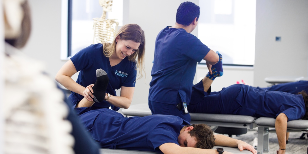 KansasCOM students participate in a simulation in an osteopathic lab setting.